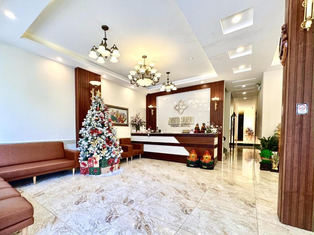 a christmas tree in the lobby of a hotel at Nam Xuan Premium Hotel in Da Lat