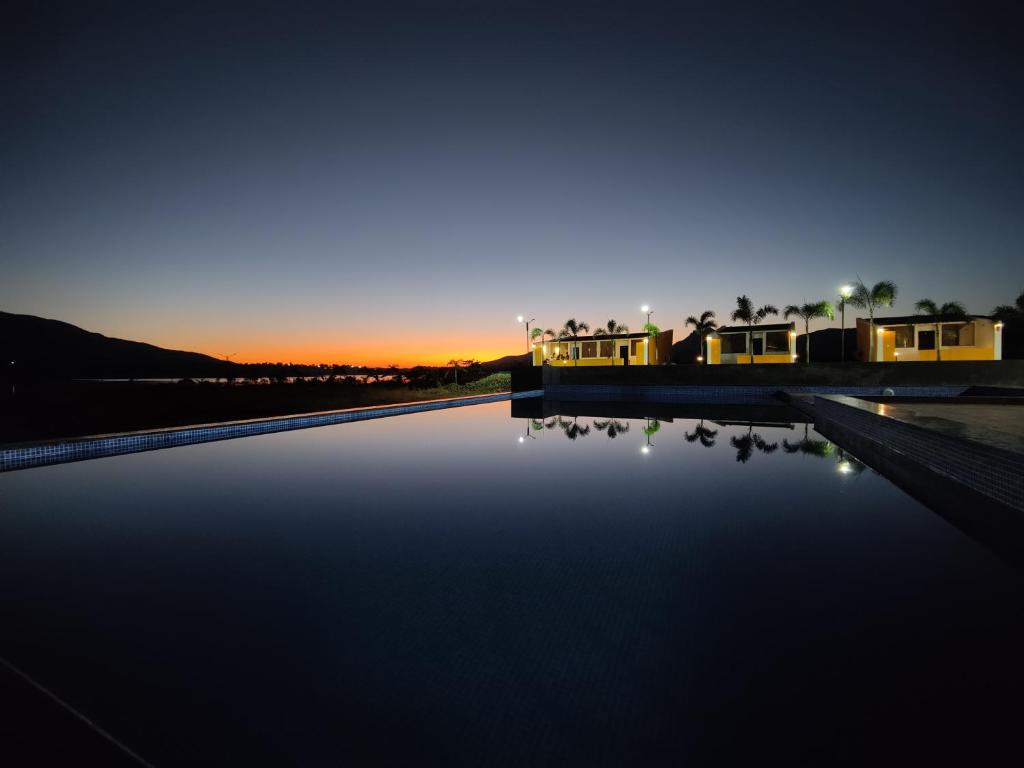 a view of a pool of water at night at Mountain N Lake Resort in Igatpuri