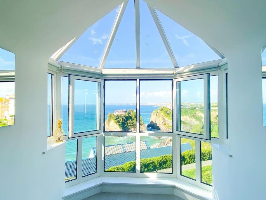 a window with a view of the ocean at Blue Horizon Penthouse - amazing views + parking! in Newquay