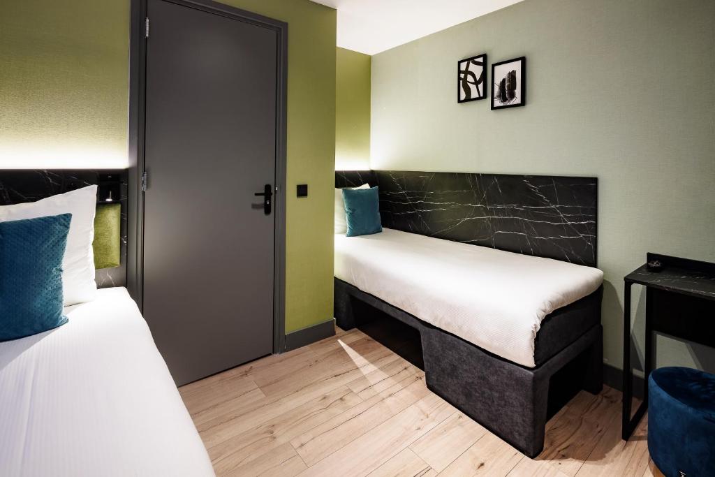 Postel nebo postele na pokoji v ubytování Ciao Papa Hotel Amsterdam Central Station