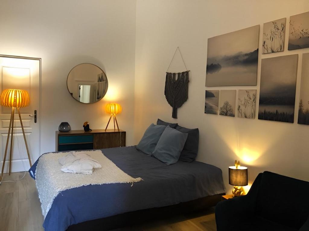 1 dormitorio con cama, espejo y silla en Clos Grimont, en Poligny