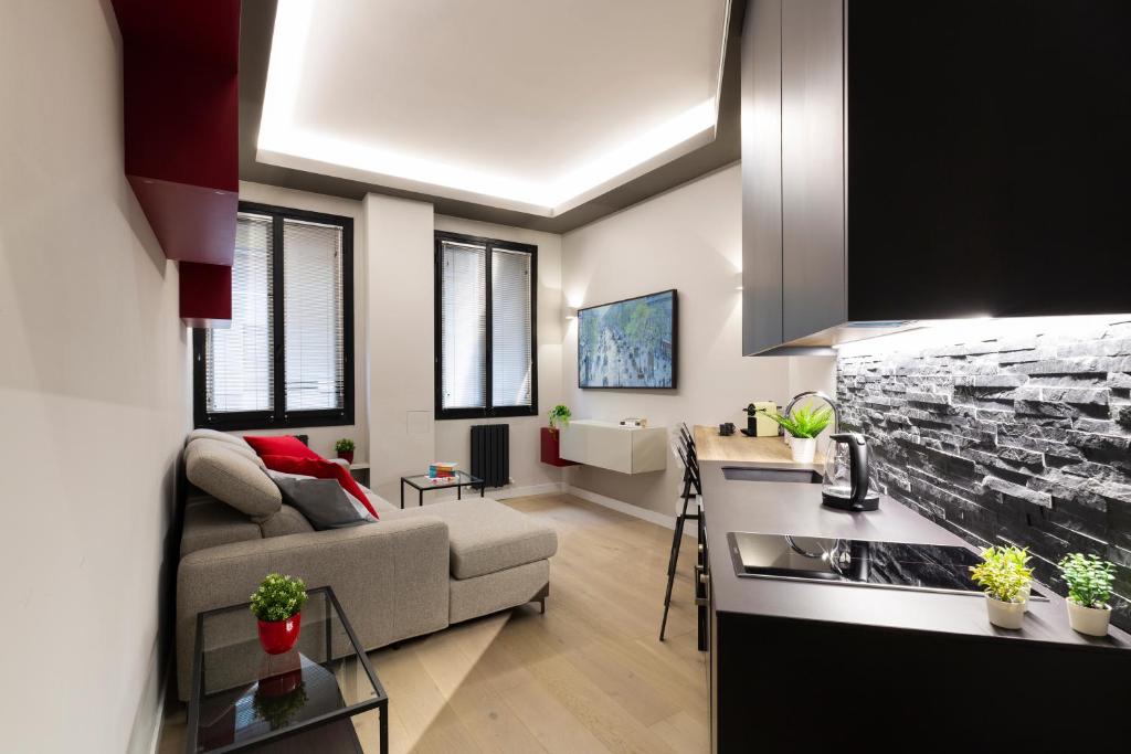 a living room with a couch and a kitchen at Special DHome in Milan