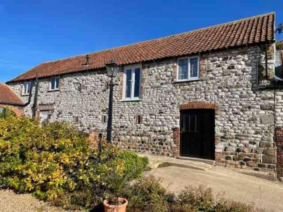 an old stone building with a black door at The Granary in Bridlington