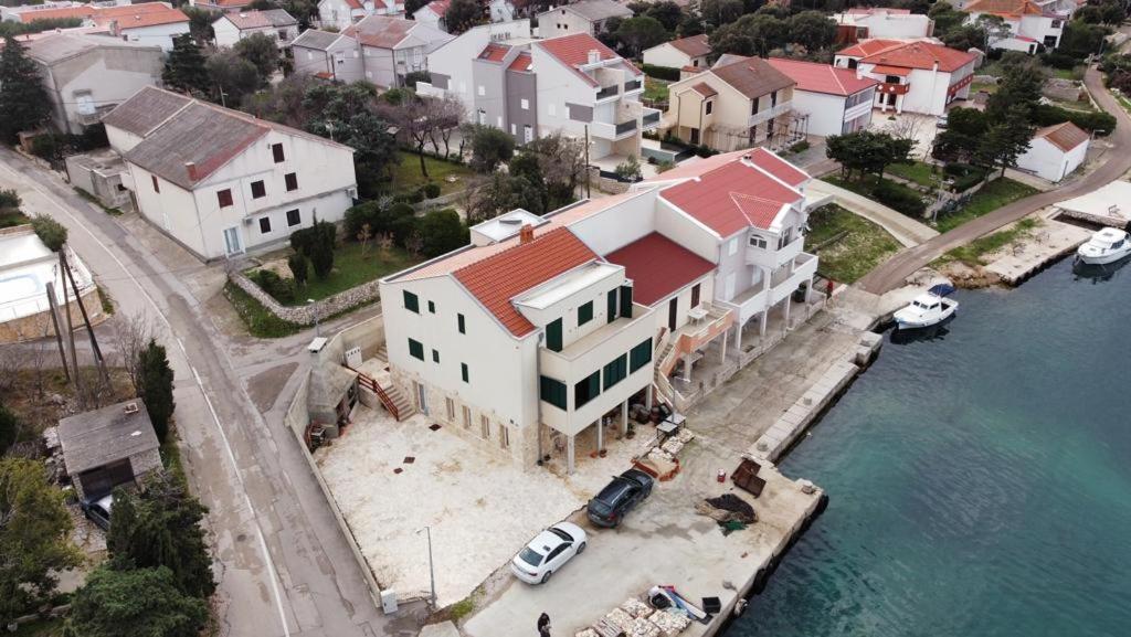 an aerial view of a house next to the water at Stara Kuća Apartments in Šimuni