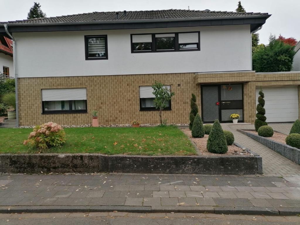 a house with a driveway in front of it at HAUS AURORA - im Grünen, zentral gelegen in Zweibrücken