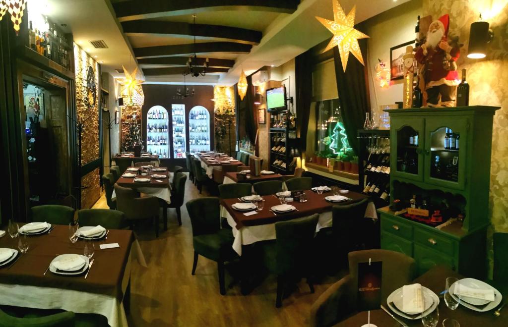 a restaurant with tables and chairs and christmas decorations at Hotel rooms & Restaurant Pirocanac in Pirot