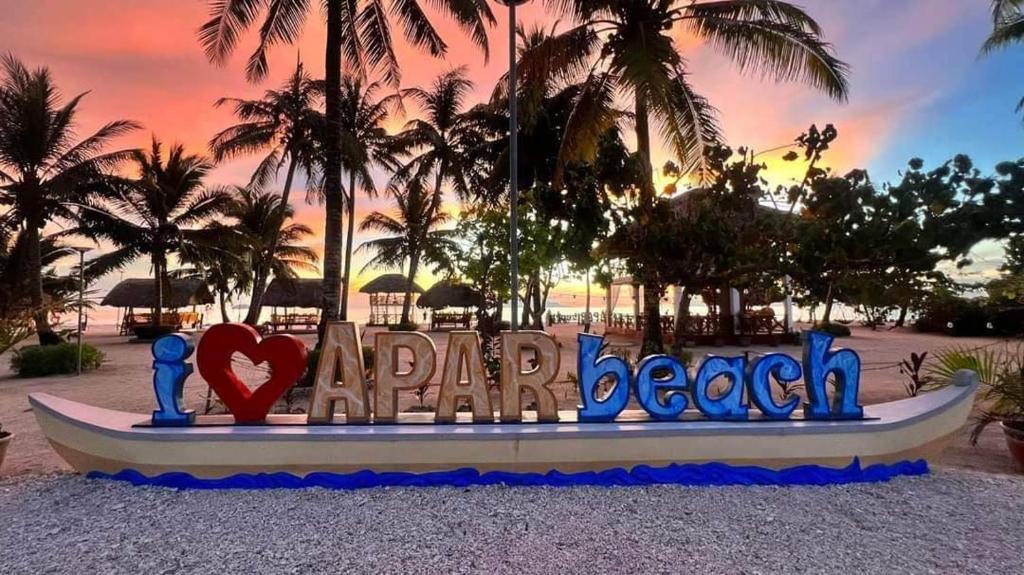 a sign that says paradise beach at a resort at Apar Beach Resort in Mataba