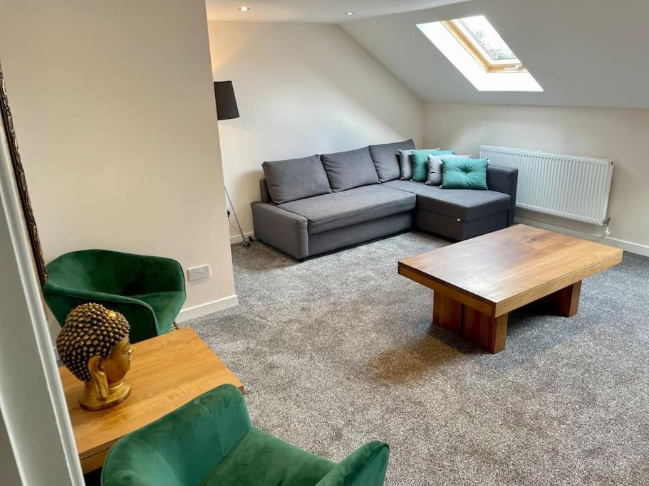 a living room with a couch and a coffee table at Vennel Street Apartments in Stewarton