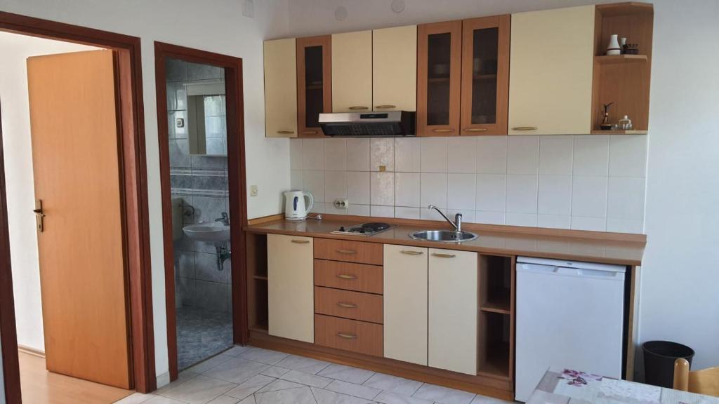 a kitchen with a sink and a counter top at Apartments Irena in Božava