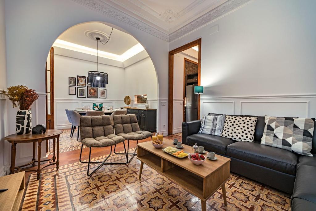 a living room with a couch and a table at Habitat Apartments Grace in Barcelona