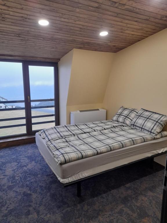 a bedroom with a bed with a view of the ocean at OZONE in Petroşani