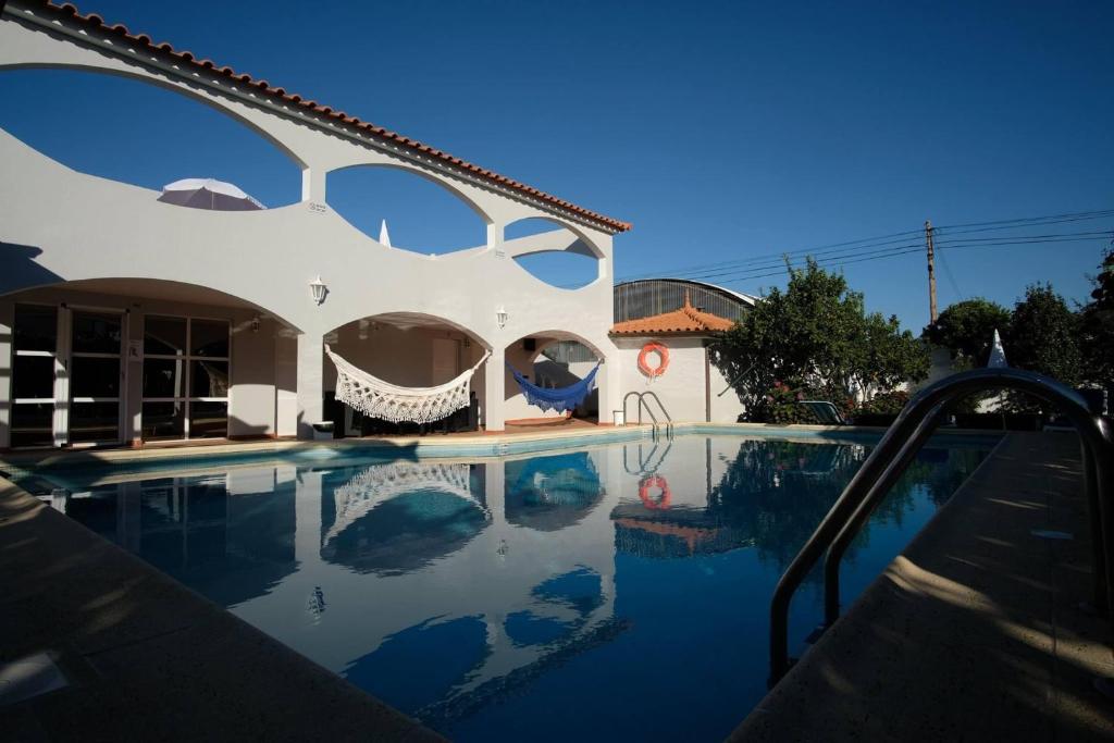 a swimming pool in front of a house at Alminhas House in Alapela