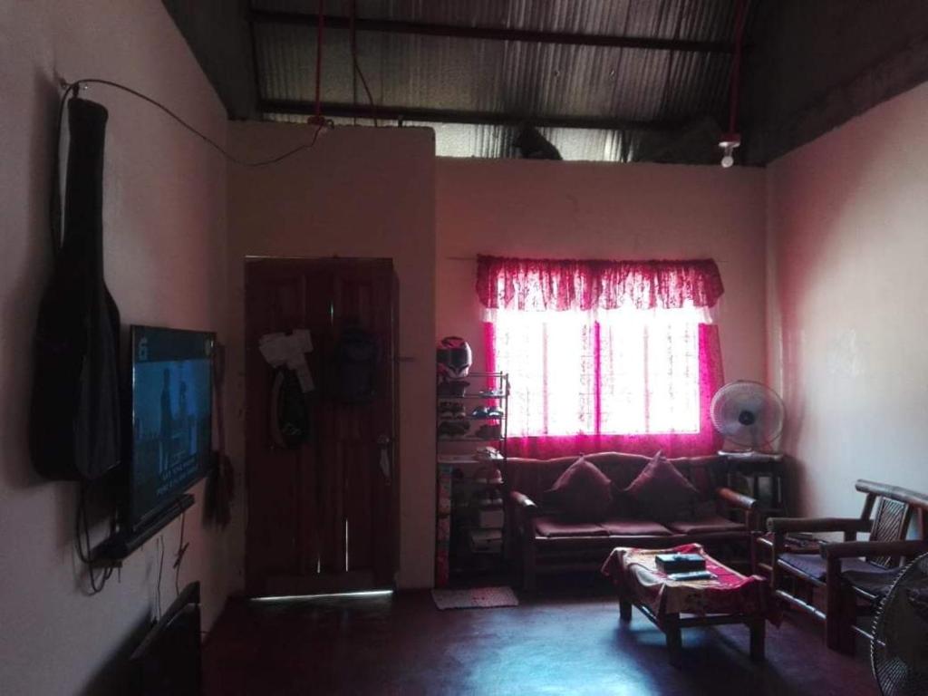 a living room with a couch and a window at Weng in Tacloban