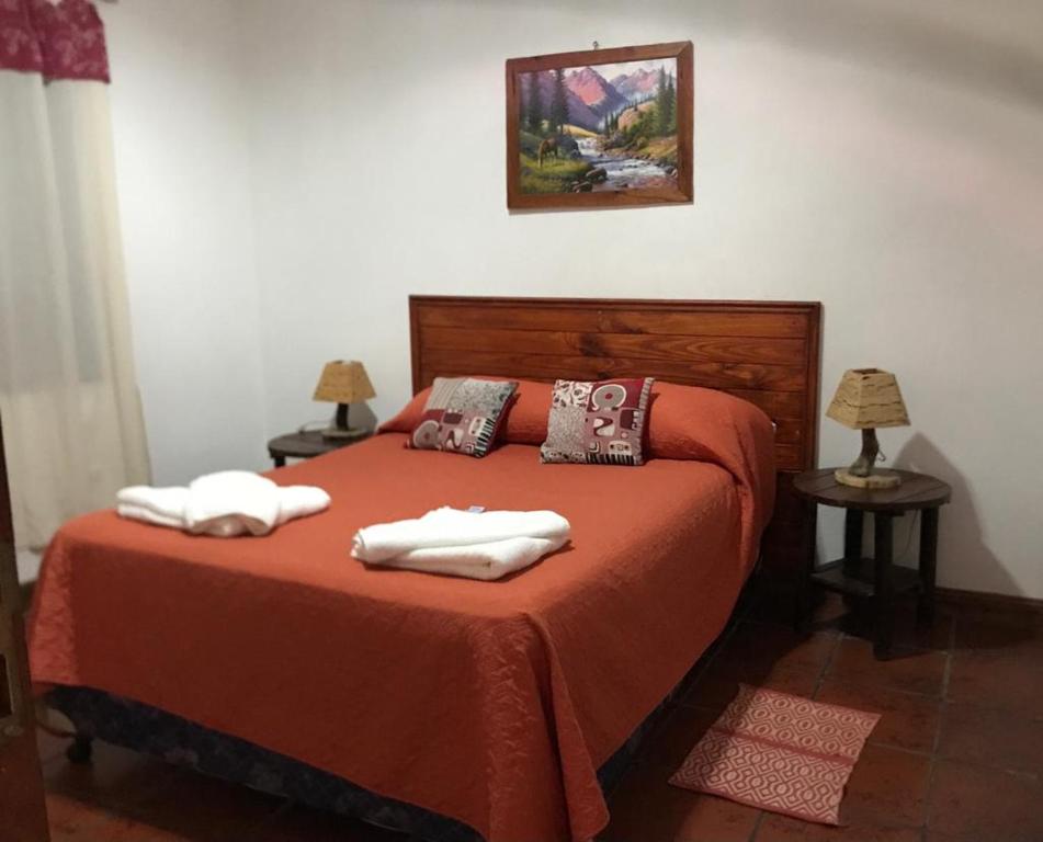 a bedroom with a bed with two towels on it at Departamento Cafayate in Cafayate