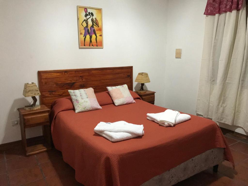 a bedroom with a bed with two towels on it at Departamento Cafayate in Cafayate