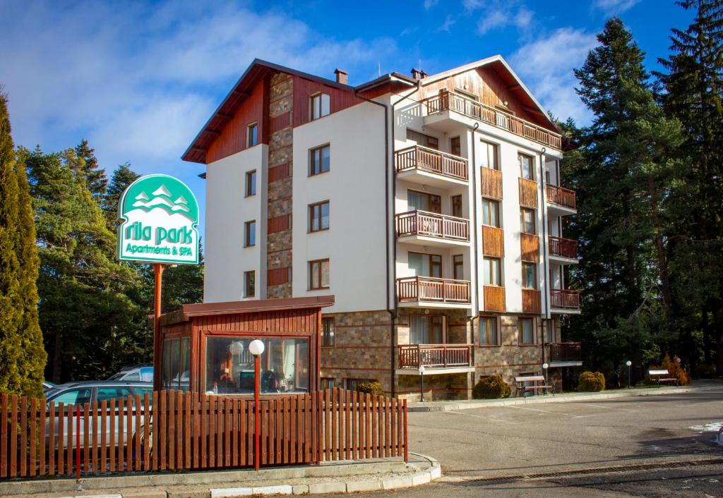 a large apartment building with a sign in front of it at GO GO RILA PARK in Borovets