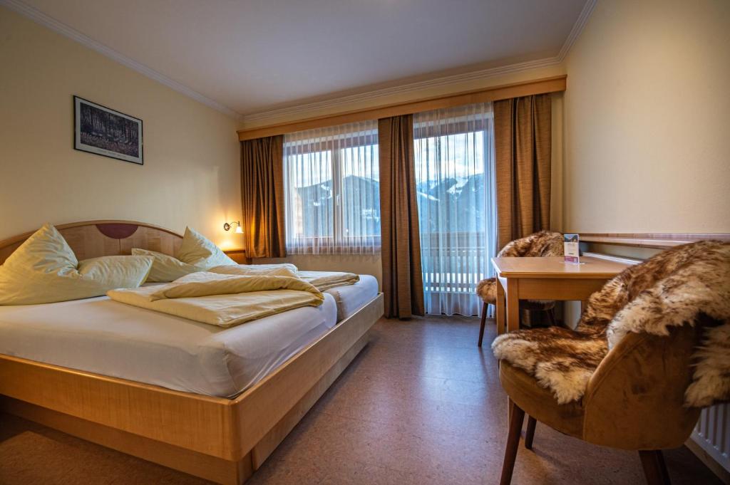 Postel nebo postele na pokoji v ubytování Hotel Raunig