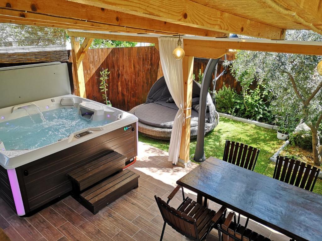 a hot tub on a patio with a table at Apartment Vespa & Jacuzzi in Split
