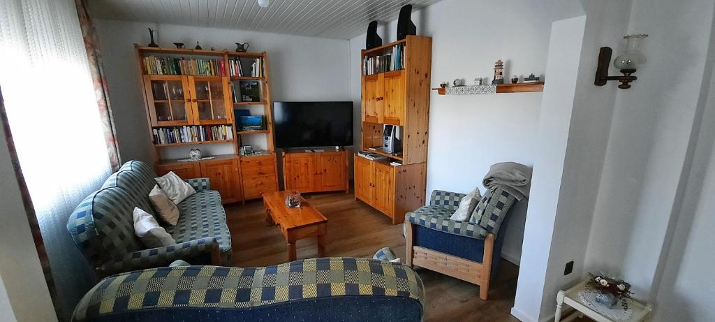 a living room with two couches and a tv at Ferienhaus Johanna in Andernach