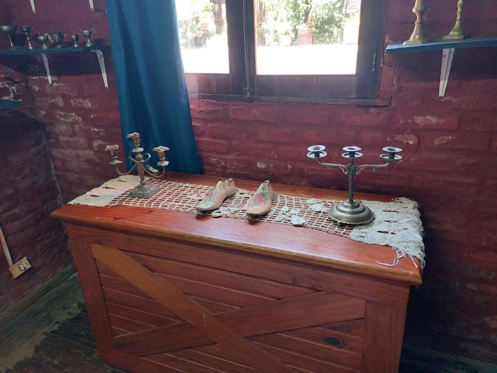a wooden counter with shoes on top of it at La Estancia hostel in Colonia del Sacramento