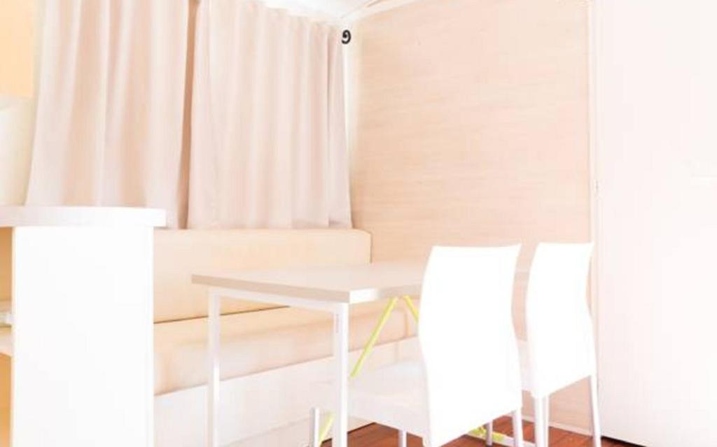 a dining room with a table and two chairs at Camping Valencia el Saler in El Saler