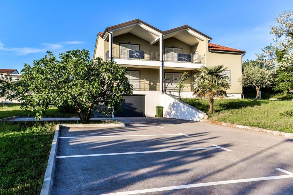 a parking lot in front of a house at Apartments Lia-Jolie in Umag