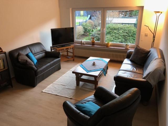 a living room with two leather couches and a coffee table at Ferienwohnung Päusken im Hochsauerland- E- Bike und Auto laden möglich in Bestwig