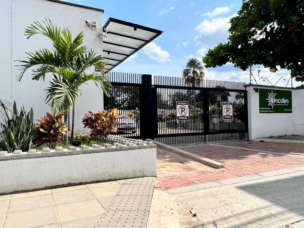 a black fence with a gate with no parking signs on it at Hotel TACALOA INN EXPERIENCE in Ricaurte