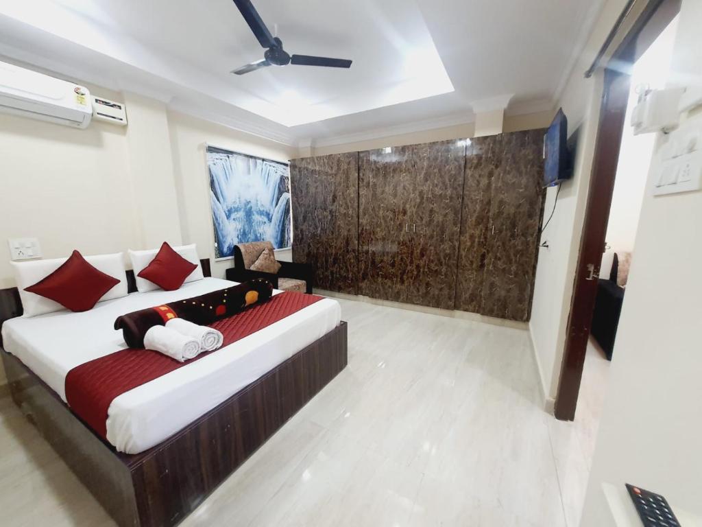 a bedroom with a large bed with red pillows at MK SUITES in Hyderabad
