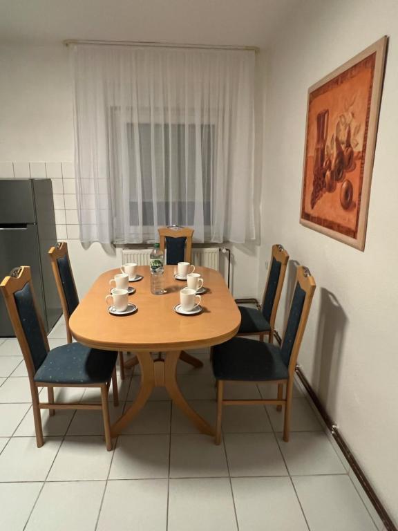 a wooden table and chairs in a kitchen at Haus Kim Thinh in Betzdorf