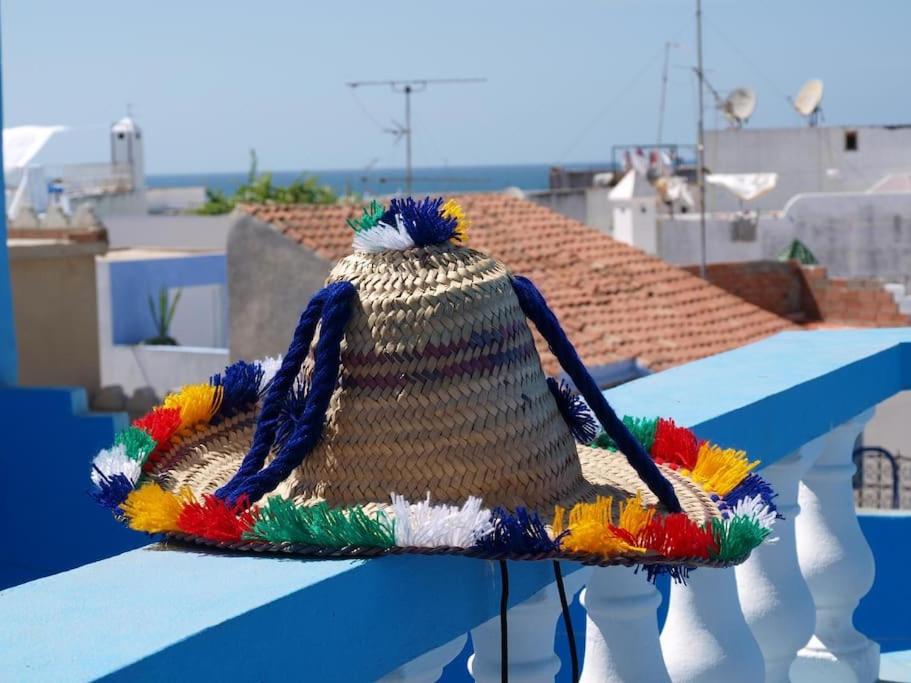 un cappello di paglia seduto su un tetto di Appartement dans la médina a Asilah