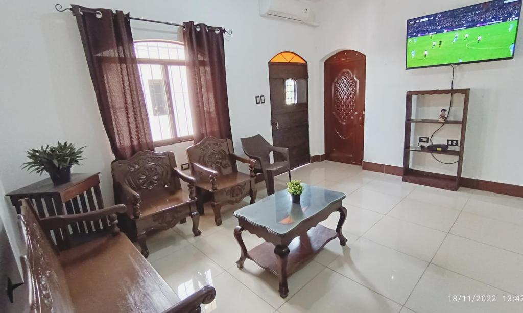 a living room with chairs and a table and a tv at Casas DiversA in Esquipulas