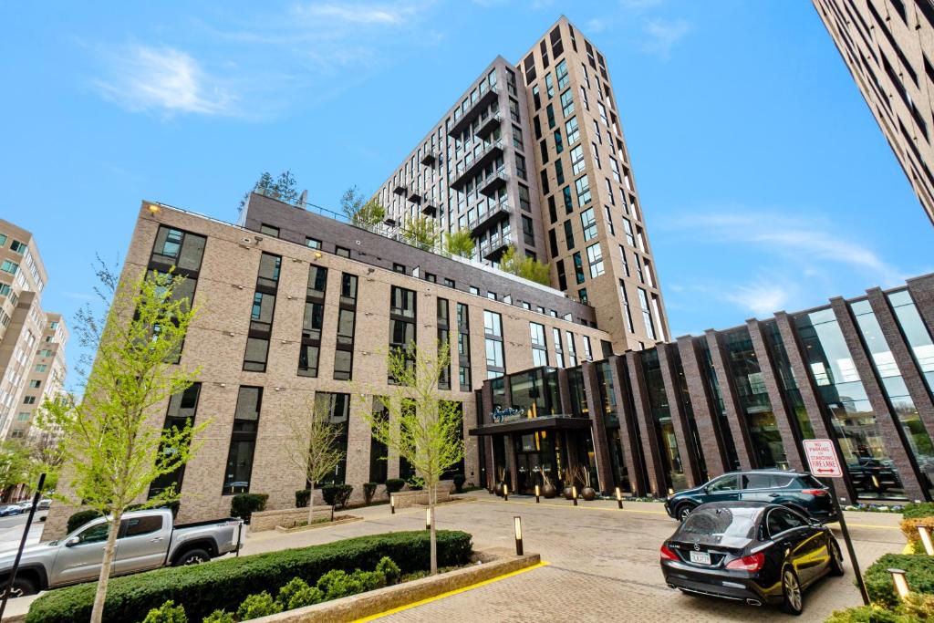 a large building with cars parked in front of it at Global Luxury Suites at Reston Town Center in Reston