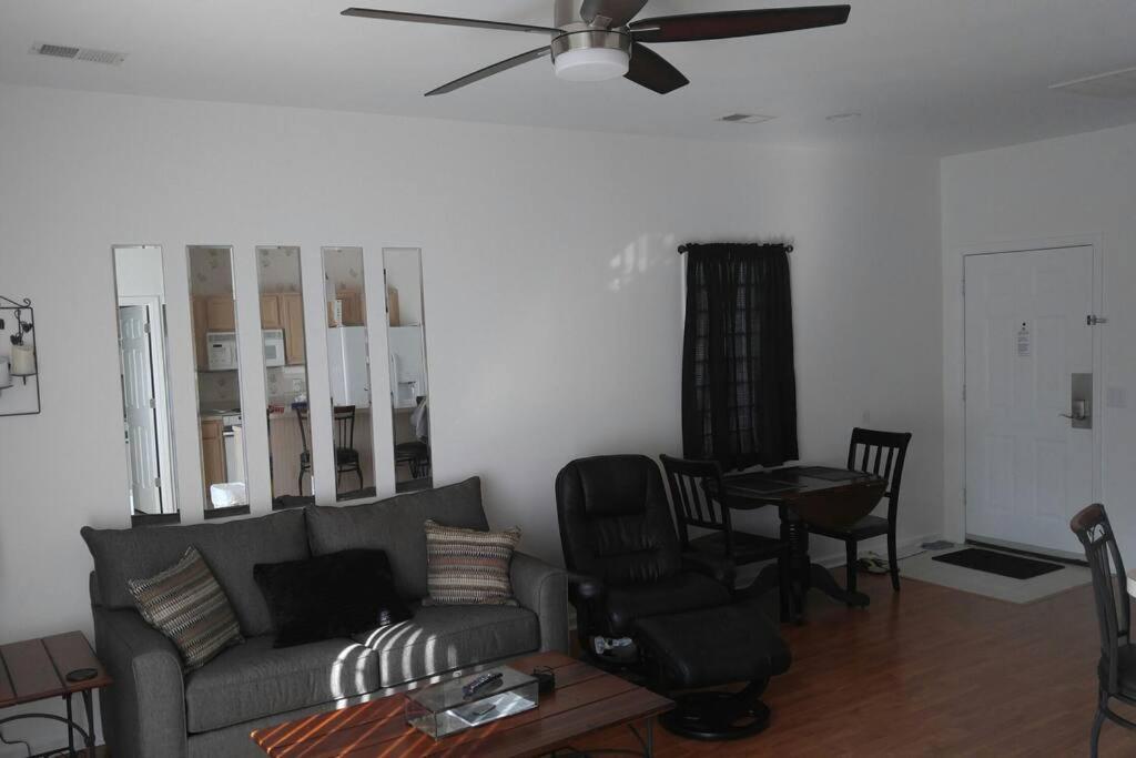 a living room with a couch and a table and chairs at Two bedroom Sea Trail condo in Sunset Beach in Sunset Beach