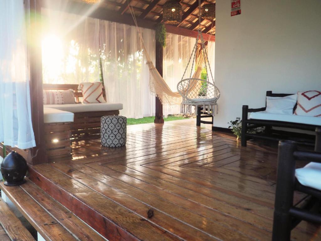a living room with a wooden floor and a hammock at Playa Bonita 4 minute walk from our private Villa Anantara Bonita in Las Terrenas