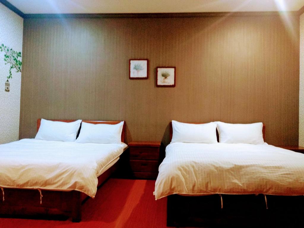 Postel nebo postele na pokoji v ubytování Ju Jia Xiao Zhan Homestay