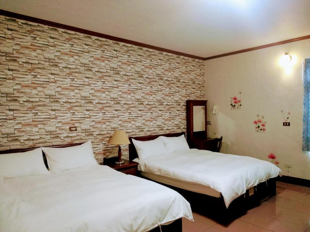 Postel nebo postele na pokoji v ubytování Ju Jia Xiao Zhan Homestay