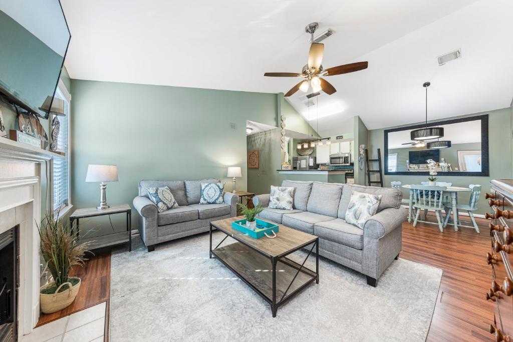 a living room with two couches and a fireplace at Cozy budget friendly condo close to the beach in Gulf Shores