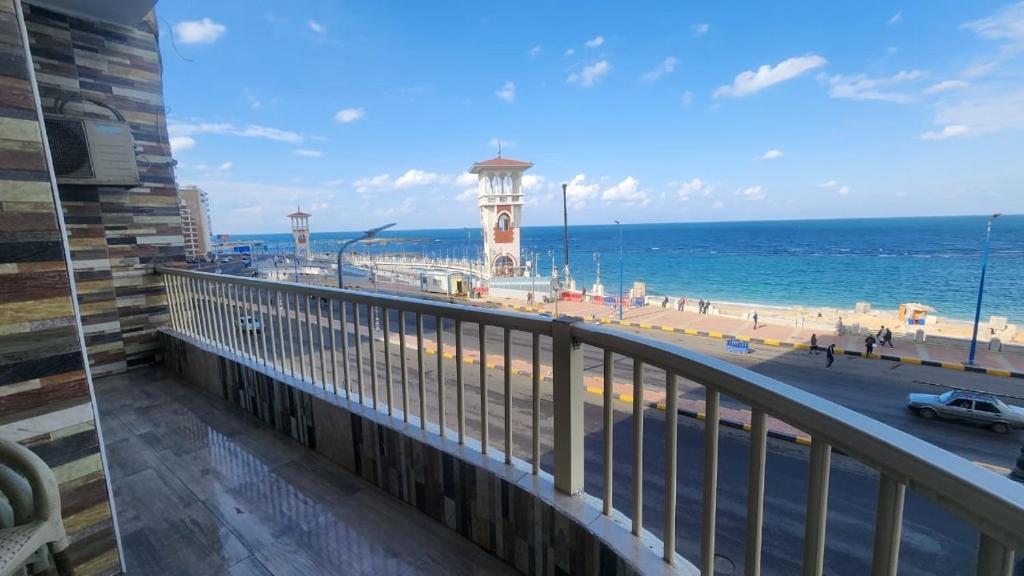 a balcony with a view of the beach and the ocean at شقة فندقية مكيفة ميامي ع البحر مباشرةً in Alexandria