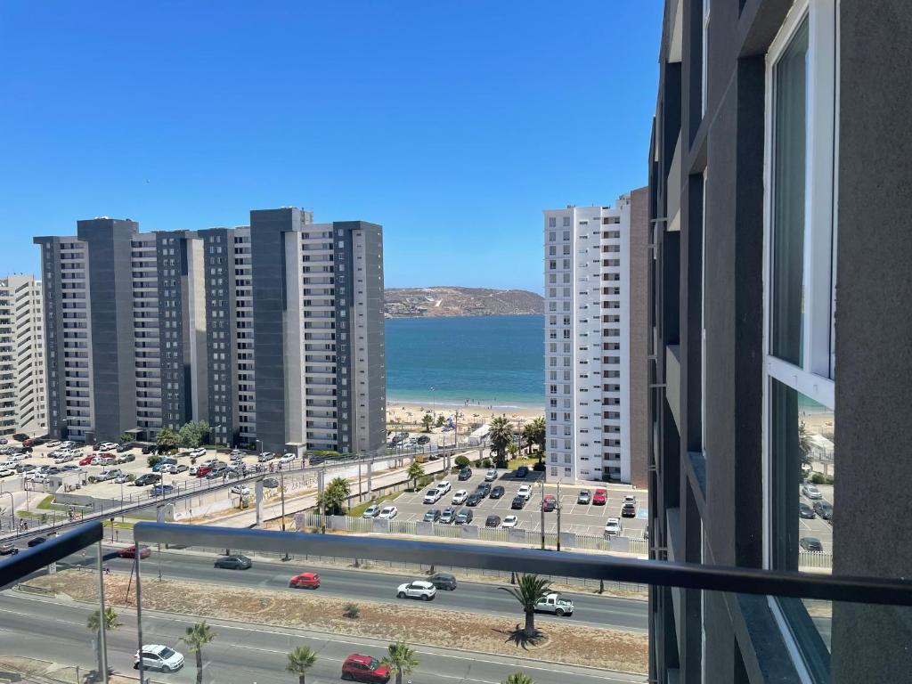 a view of a city with buildings and the ocean at Costa Herradura in Coquimbo