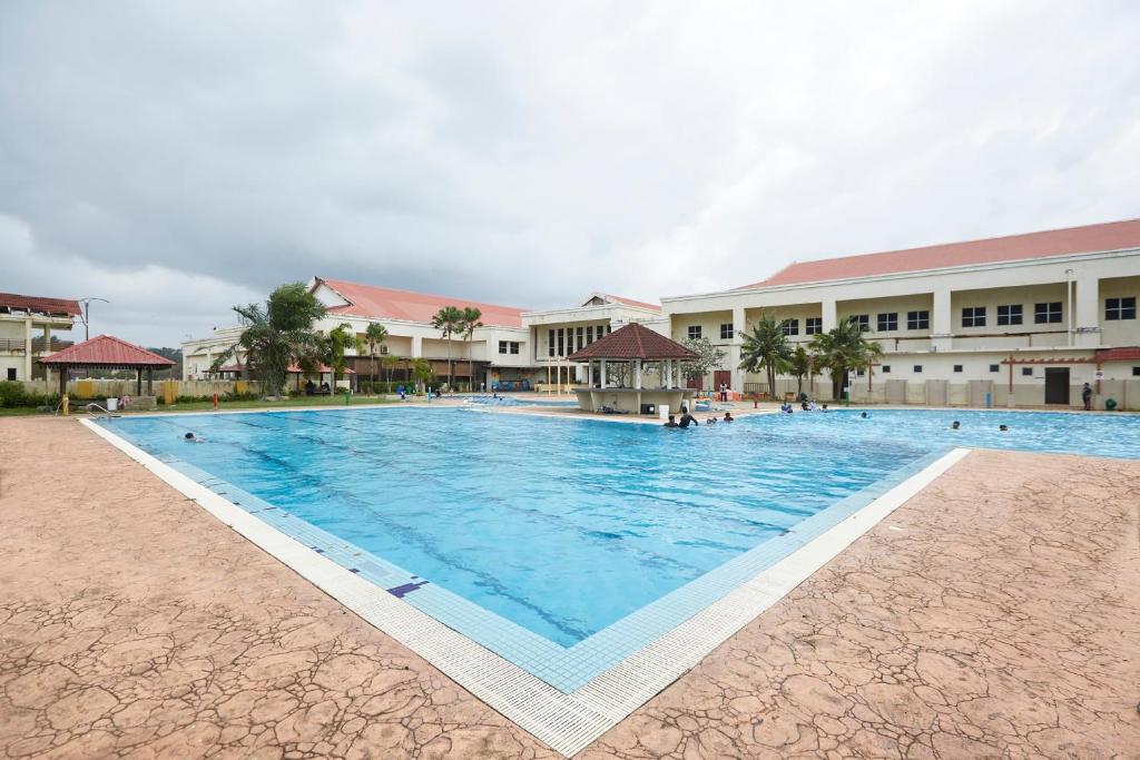 a large swimming pool in front of a building at Terengganu Equestrian Resort in Kuala Terengganu