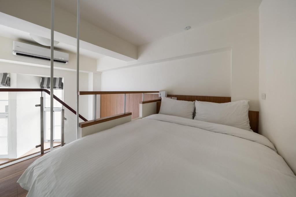Postel nebo postele na pokoji v ubytování Anping Kensington Hotel