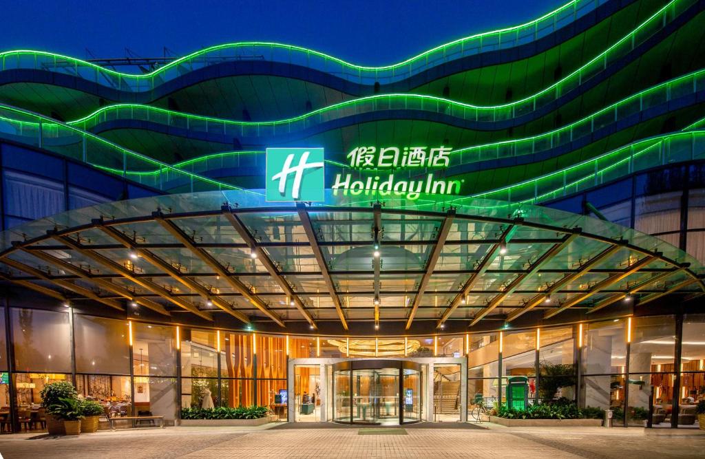 un edificio con un cartel en la parte delantera en Holiday Inn Nanjing Xuanwu Lake, an IHG Hotel, en Nanjing