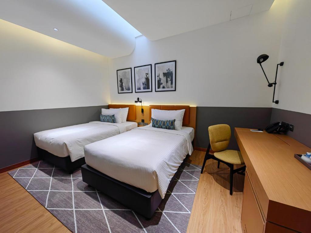 Postel nebo postele na pokoji v ubytování Citadines Connect Georgetown Penang