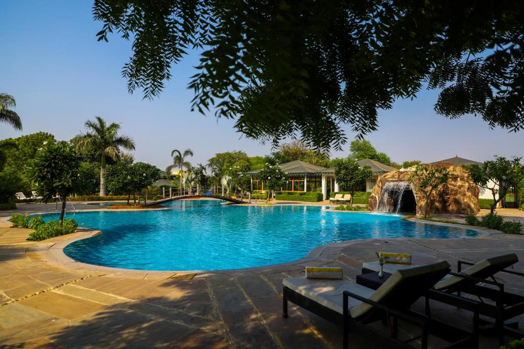 a large swimming pool with a water slide at The Baagh Ananta Elite Ranthambore in Khilchipur