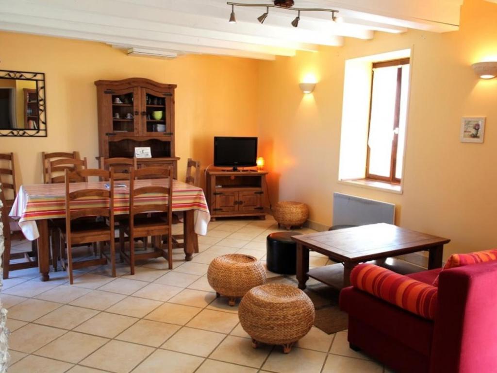 a living room with a table and a dining room at Gîte Saint-Sauvier, 3 pièces, 6 personnes - FR-1-489-404 
