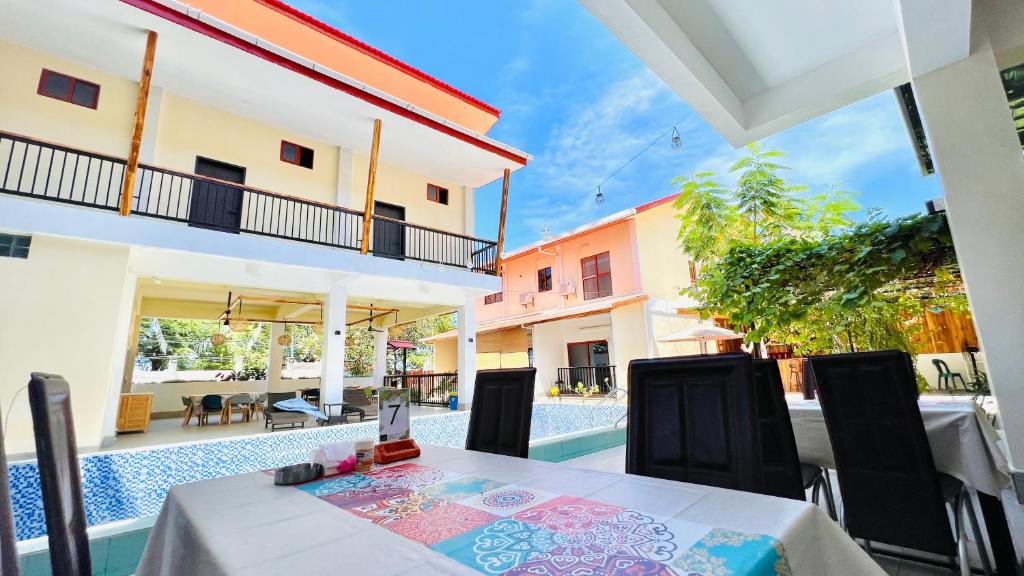 a dining room with a table and a pool at M Y hotel in Dili