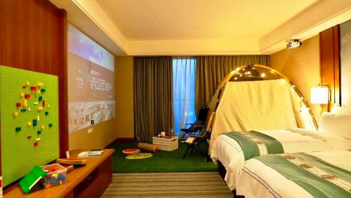 a hotel room with a bedroom with a bed and a screen at Fullon Hotel Tamsui Fishermen&#39;s Wharf in Tamsui
