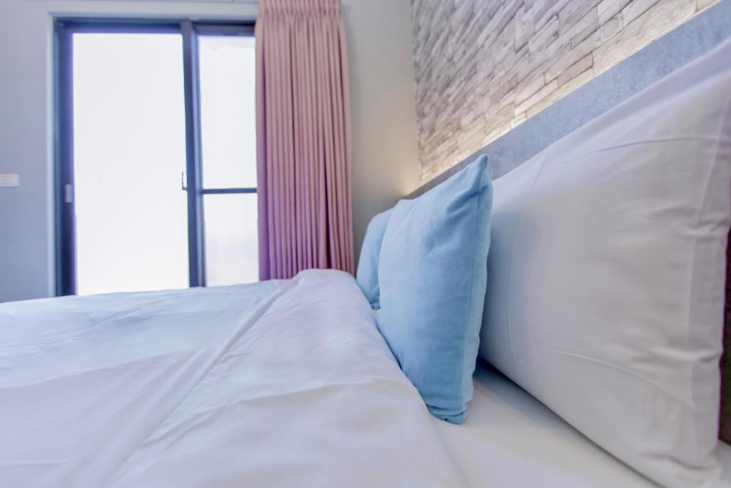 Postel nebo postele na pokoji v ubytování Huayu Homestay