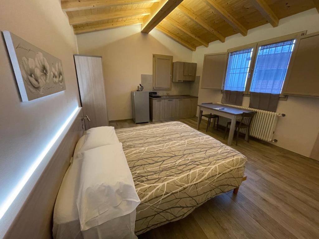 a bedroom with a bed and a table in it at Agriturismo Ravaglia Grande in Castel Guelfo di Bologna